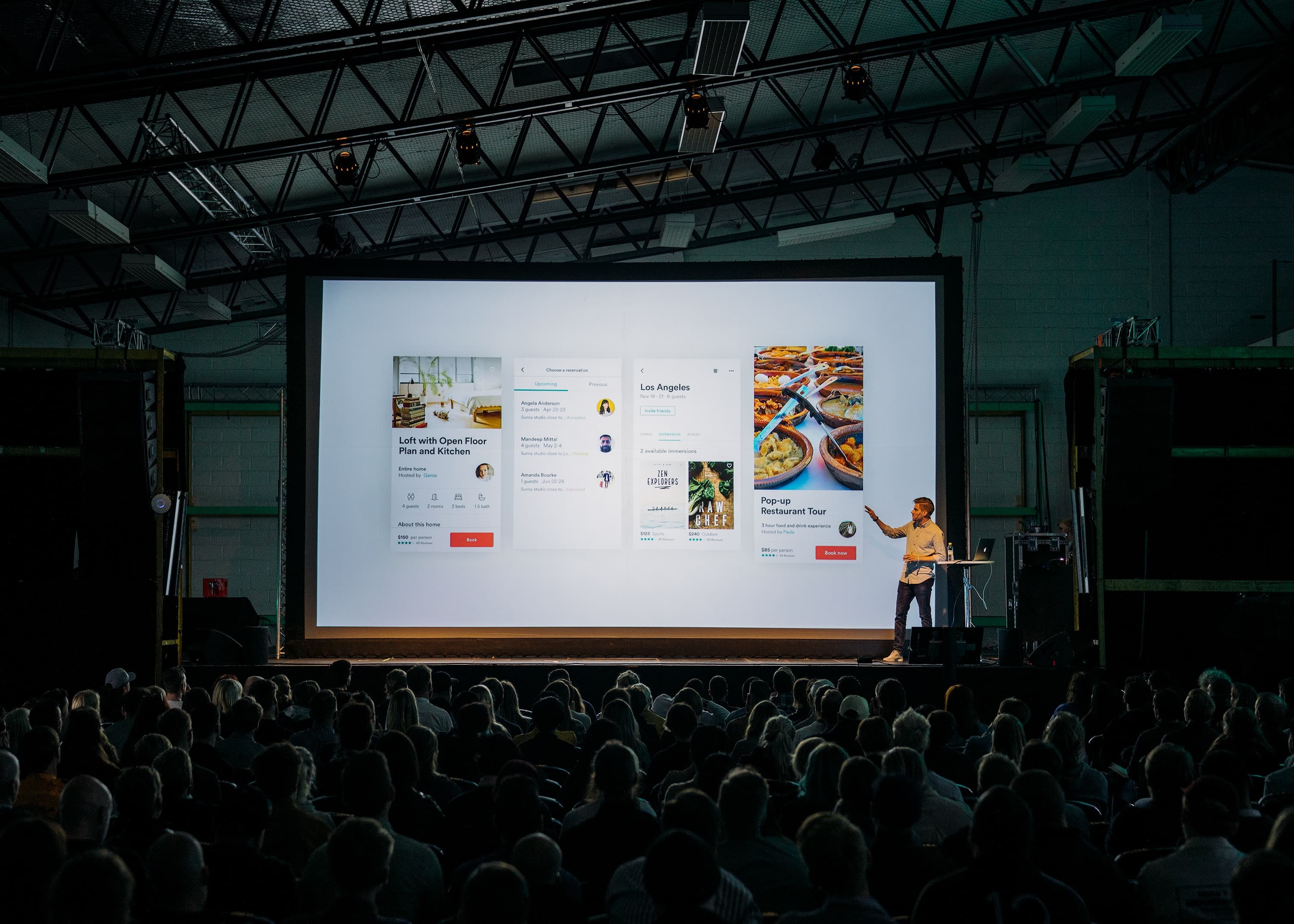 Person talking in front of a big screen