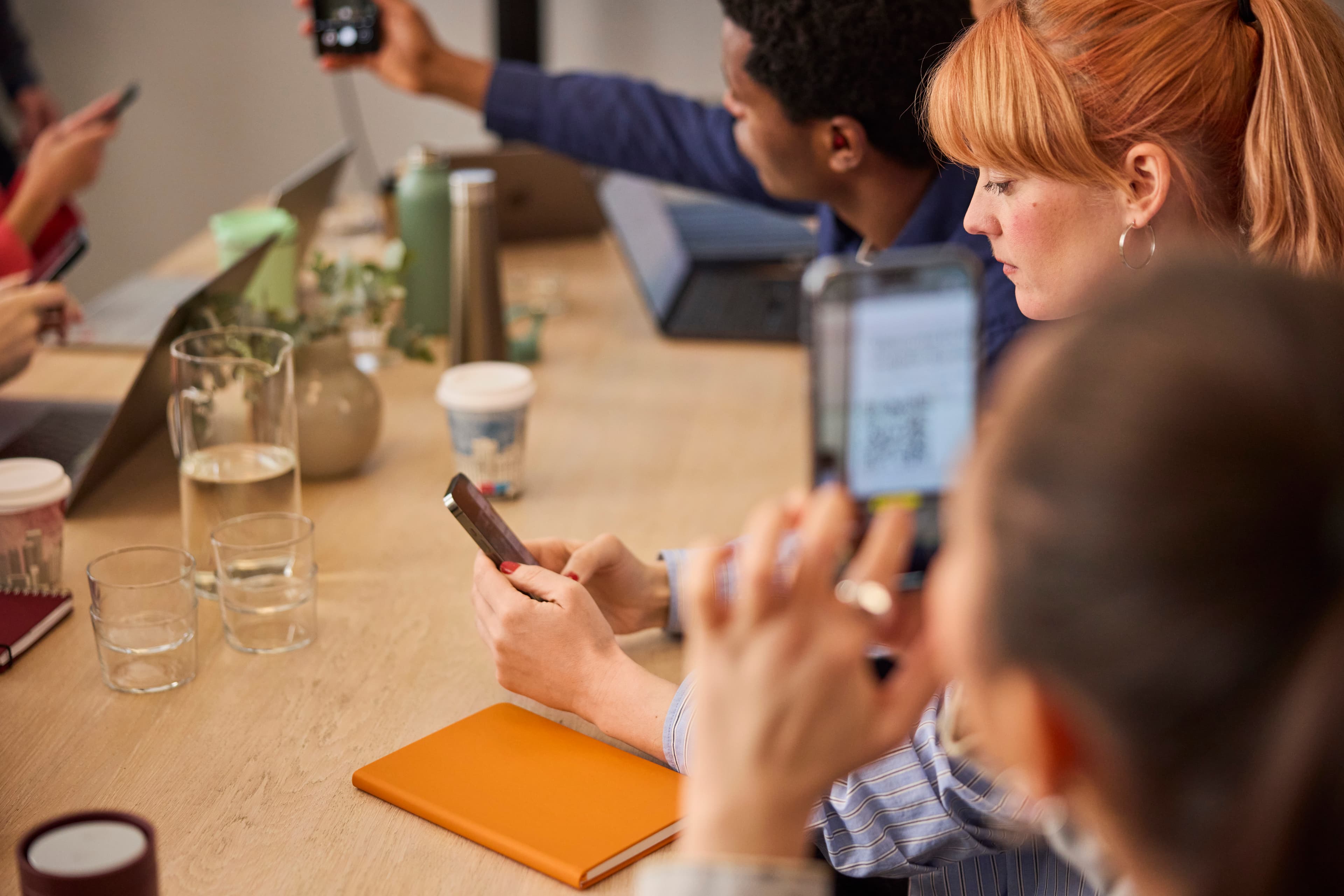 Woman at table with phone